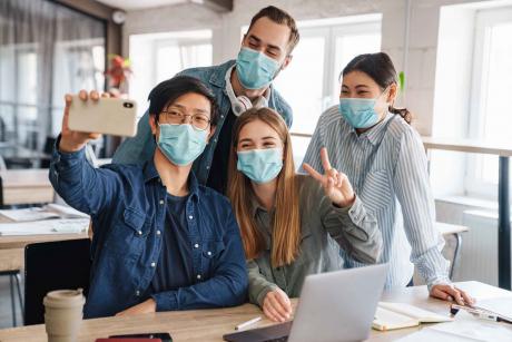 Photo Of Cheerful Students in Medical Masks Taking